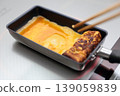 Cook an omelet and burn it. 139059839