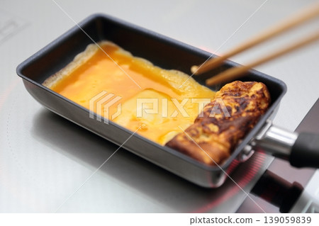 Cook an omelet and burn it. 139059839