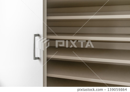 Storage cabinet with white doors and wood-grain shelves Storage cabinet with white doors and wood-grain shelves 139059864