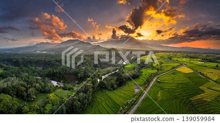 Beautiful morning view in Indonesia, panoramic landscape of rice fields with mountain ranges and clear sky Beautiful morning view in Indonesia, panoramic landscape of rice fields with mountain ranges and clear sky 139059984
