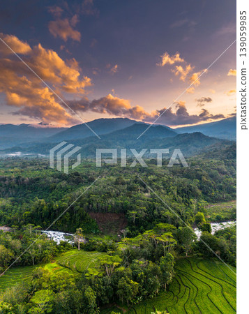 Beautiful morning view in Indonesia, panoramic landscape of rice fields with mountain ranges and clear sky Beautiful morning view in Indonesia, panoramic landscape of rice fields with mountain ranges and clear sky 139059985
