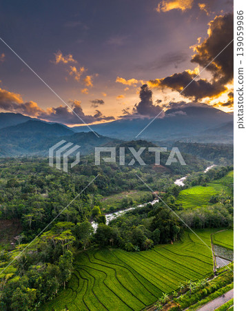 Beautiful morning view in Indonesia, panoramic landscape of rice fields with mountain ranges and clear sky Beautiful morning view in Indonesia, panoramic landscape of rice fields with mountain ranges and clear sky 139059986