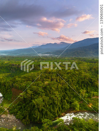 Beautiful morning view in Indonesia, panoramic landscape of rice fields with mountain ranges and clear sky Beautiful morning view in Indonesia, panoramic landscape of rice fields with mountain ranges and clear sky 139060001