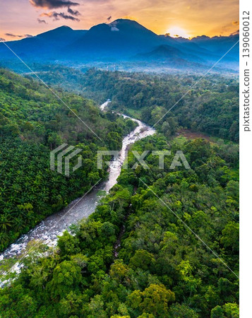 Beautiful morning view in Indonesia, panoramic landscape of rice fields with mountain ranges and clear sky Beautiful morning view in Indonesia, panoramic landscape of rice fields with mountain ranges and clear sky 139060012