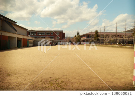 School grounds and school building, clouds in the blue sky, schoolyard 139060081