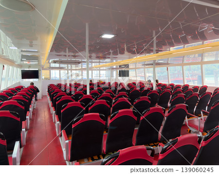 Empty rows of red passenger seats inside a modern transport ferry. Empty rows of red passenger seats inside a modern transport ferry. 139060245