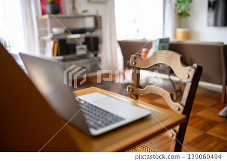 A laptop placed on a chair at home 139060494