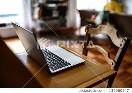 A laptop placed on a chair in the living room 139060547