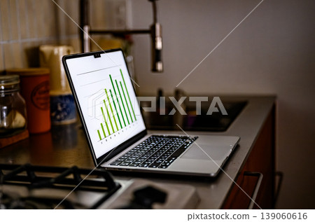 A laptop used to view graphs in the kitchen 139060616