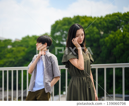 綠色背景上,一對神情憂鬱的年輕男女的肖像。 綠色背景上,一對神情憂鬱的年輕男女的肖像。 139060706