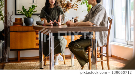 Close-up of a man and woman talking across a table Close-up of a man and woman talking across a table 139060712