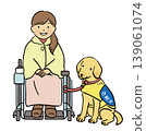 A woman in a wheelchair and her service dog 139061074