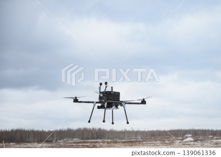 Armed bomber drone carrying payload in flight 139061336