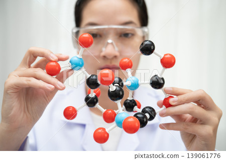 Scientist holding molecular model for chemical technology. 139061776