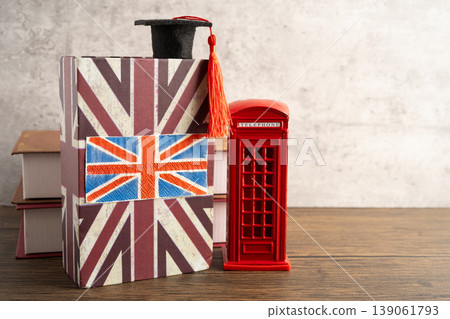 UK flag with graduate hat on english language book. UK flag with graduate hat on english language book. 139061793