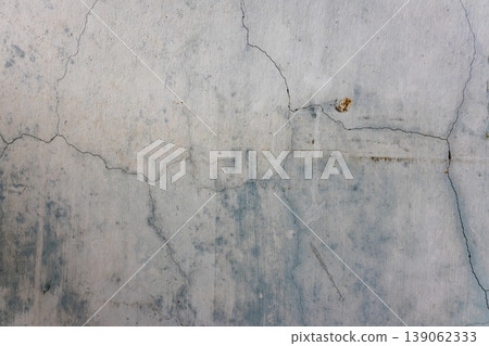 A cracked, inorganic concrete wall A cracked, inorganic concrete wall 139062333