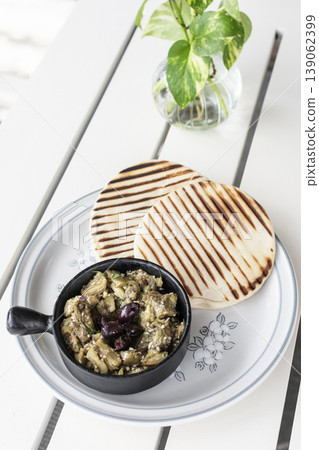 Roasted mashed Eggplant tapas snack on white table in outdoor restaurant in greece 139062399