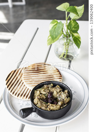 Roasted mashed Eggplant tapas snack on white table in outdoor restaurant in greece 139062400