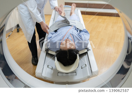 Patient undergoing a CT scan at a hospital. Photography cooperation: Denpa Gakuen Educational Foundation, Tokyo Electronics College. Patient undergoing a CT scan at a hospital. Photography cooperation: Denpa Gakuen Educational Foundation, Tokyo Electronics College. 139062587