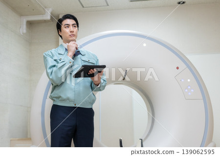 Engineers maintaining hospital CT scanners. Photo courtesy of Denpa Gakuen Educational Foundation, Tokyo Electronics College. Engineers maintaining hospital CT scanners. Photo courtesy of Denpa Gakuen Educational Foundation, Tokyo Electronics College. 139062595