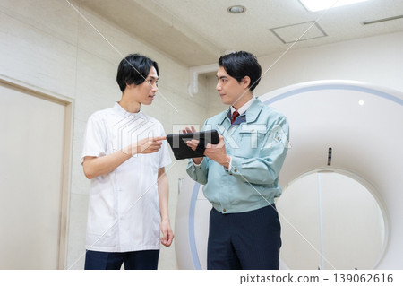 Engineers and doctors maintaining a hospital's CT scanner. Photo courtesy of Denpa Gakuen Educational Foundation, Tokyo Electronics College. Engineers and doctors maintaining a hospital's CT scanner. Photo courtesy of Denpa Gakuen Educational Foundation, Tokyo Electronics College. 139062616
