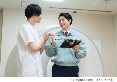 Engineers and doctors maintaining a hospital's CT scanner. Photo courtesy of Denpa Gakuen Educational Foundation, Tokyo Electronics College. Engineers and doctors maintaining a hospital's CT scanner. Photo courtesy of Denpa Gakuen Educational Foundation, Tokyo Electronics College. 139062618