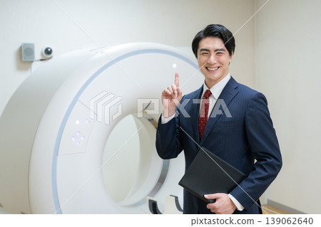 A businessman maintaining a hospital's CT scanner. Filming assistance provided by: Denpa Gakuen Educational Foundation, Tokyo Electronics College. A businessman maintaining a hospital's CT scanner. Filming assistance provided by: Denpa Gakuen Educational Foundation, Tokyo Electronics College. 139062640