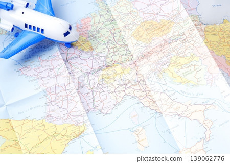 European Travel - An image of a passenger plane flying over Europe, representing an air journey to Europe. 139062776