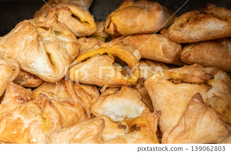 Cheese puffs stuffed with chicken or vegetables on display at street food market Cheese puffs stuffed with chicken or vegetables on display at street food market 139062803