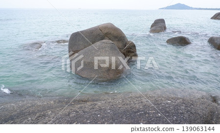 Sea Water Ripples Around Granite Rocks in the Morning 139063144