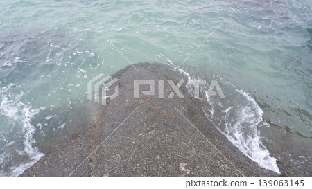 Rounded Granite Stone in Shallow Tropical Ocean 139063145