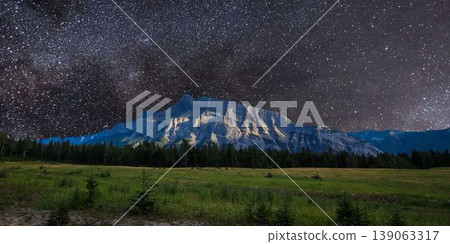 a beautiful night shot of a mountain in the night starry sky 139063317