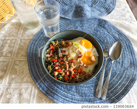 Authentic Thai food, spicy stir-fried minced pork with holy basil (Pad Kra Pao) topped with double fried eggs on rice. 139063684