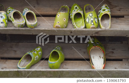 Painted Old Dutch Wooden Clogs on Weathered Rustic Shelf Painted Old Dutch Wooden Clogs on Weathered Rustic Shelf 139063793