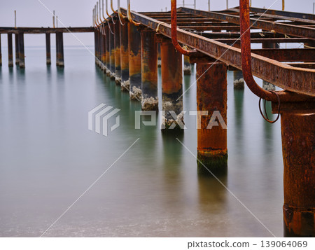 old pier on the beach and long exposure sea waves old pier on the beach and long exposure sea waves 139064069