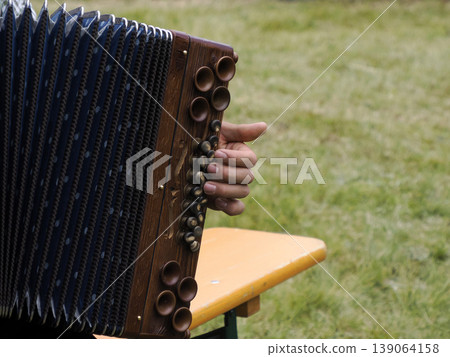 hands playing alpine bavarian accordion 139064158