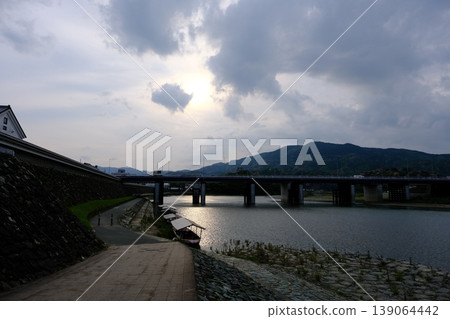 A bridge over the Hijikawa River in Ozu City, with Ozu Castle visible in the distance. A bridge over the Hijikawa River in Ozu City, with Ozu Castle visible in the distance. 139064442