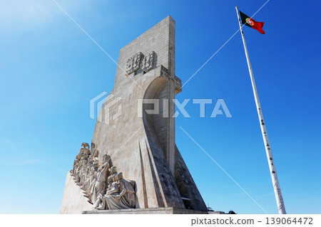 Monument of the Discoveries in Lisbon with Portuguese Flag 139064472