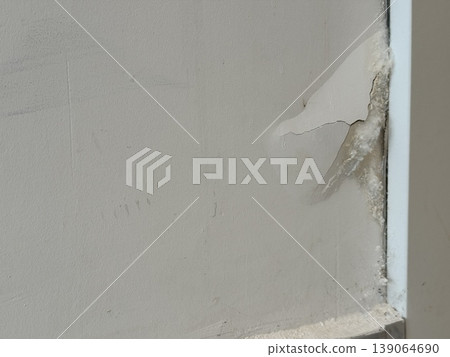 Wall corner with visible water damage and peeling paint texture as background 139064690