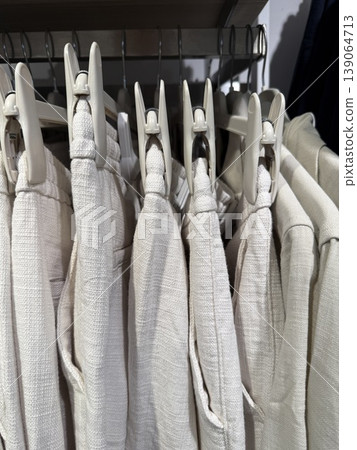 White fabrics neatly arranged with clothespins, creating a textured background in a storage setting White fabrics neatly arranged with clothespins, creating a textured background in a storage setting 139064713