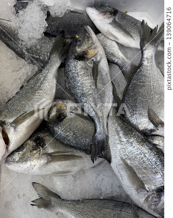 Fresh fish on ice at seafood market showcasing variety of species for sale and culinary use 139064716