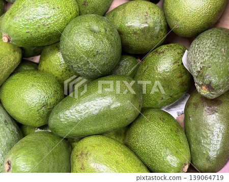 Avocado pile showing fresh green avocados in close-up suitable for food or nutrition background Avocado pile showing fresh green avocados in close-up suitable for food or nutrition background 139064719
