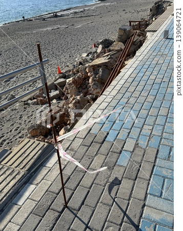 Damaged sidewalk with exposed rebar due to erosion at beach location creating a safety hazard Damaged sidewalk with exposed rebar due to erosion at beach location creating a safety hazard 139064721
