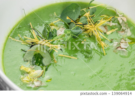 Green detox cream soup macro texture vegan puree with microgreens gourmet food background 139064914