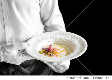 Waiter serving gourmet cream soup fine dining restaurant service concept 139064915