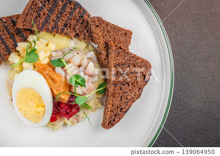 Herring salad with egg potato and rye bread top view copy space 139064950