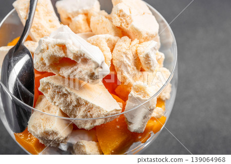 British dessert Eton mess with peach meringue and cream in glass close up British dessert Eton mess with peach meringue and cream in glass close up 139064968