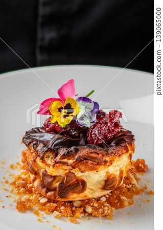 Gourmet dessert with berries and edible flowers on plate Gourmet dessert with berries and edible flowers on plate 139065000