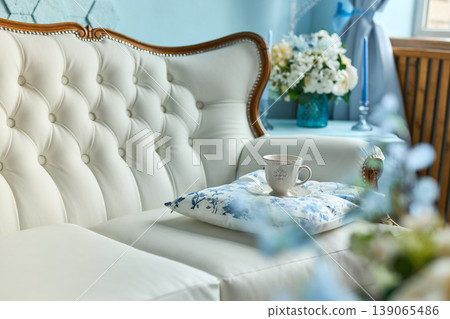 Elegant White Sofa with Tea Cup and Pillow Elegant White Sofa with Tea Cup and Pillow 139065486
