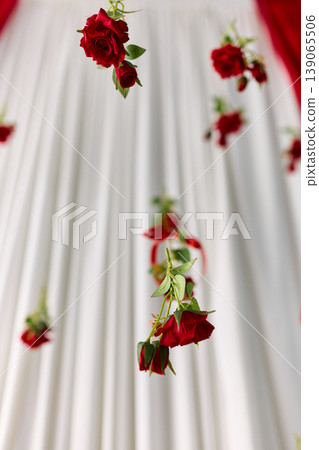 Romantic Detail of Hanging Red Roses Backdrop Romantic Detail of Hanging Red Roses Backdrop 139065506